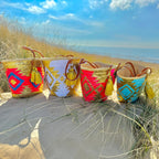 Boho rattan beach bag Aztec gold and fuchsia, together with other Aztec bags in the dunes