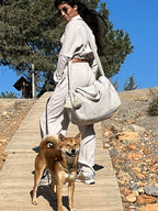 Gestreepte travel bag beige, gedragen tijdens een wandeling