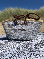 Large straw beach bag with sequins silver, front view in the dunes