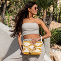 Hippie clutch and toiletry bag ochre and beige, held in the hand
