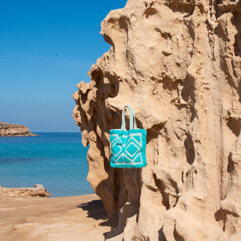 Ibiza beach bag Laguna blue, on a rock with a sea view