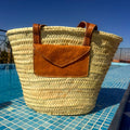 Rattan shoulder bag with leather handles and envelope pocket, with envelope pocket by the pool