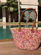 Straw beach bag Multi with sequins without tassels, front view by the pool