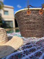 Straw beach bag with sequins brown, on a beach blanket
