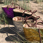 Straw beach bag with sequins purple, together with other sequin bags in the dunes