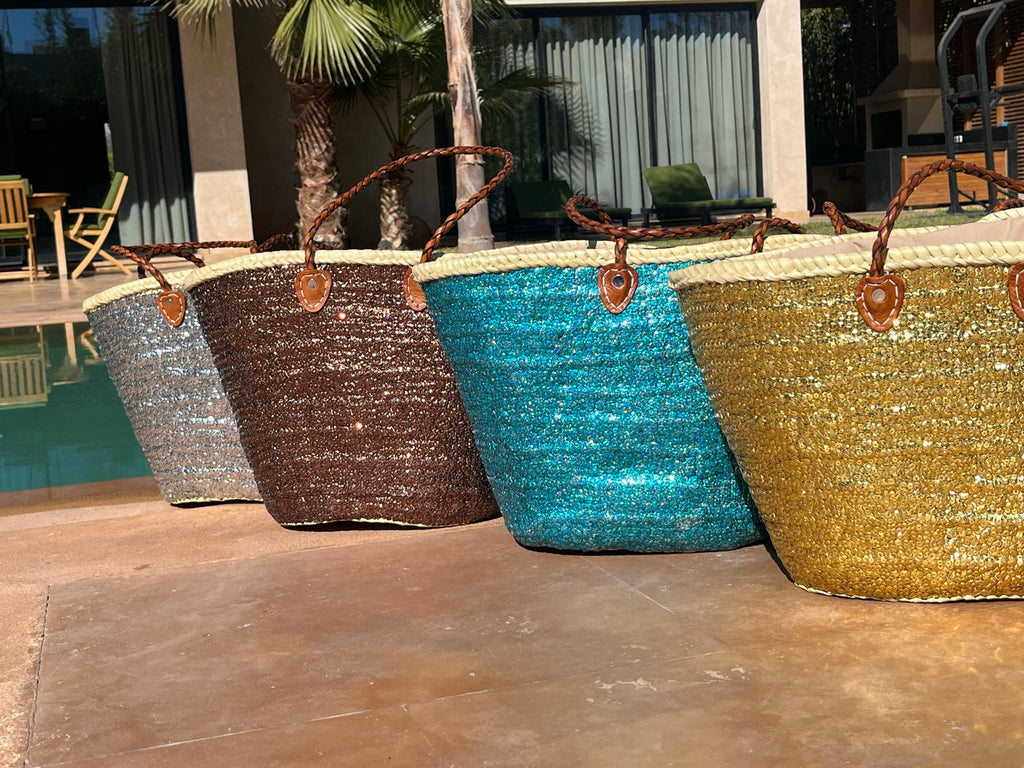 Rieten strandtas met pailletten turquoise, samen met andere kleuren bij het zwembad