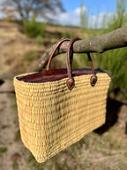 Rattan bag Faria with leather closure, outdoors in nature