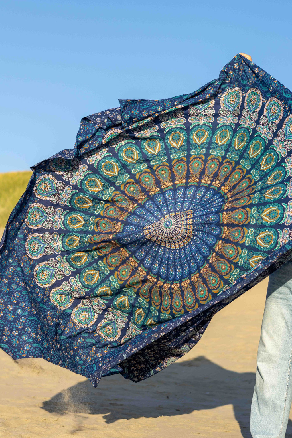 XXL beach towel Blue Paradise billowing in the wind on the beach