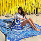 XXL beach towel Star Blue 235x220 cm, with a woman sitting on the beach