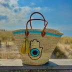 Boho rattan beach bag Hamsa Marrakech, front view in the dunes