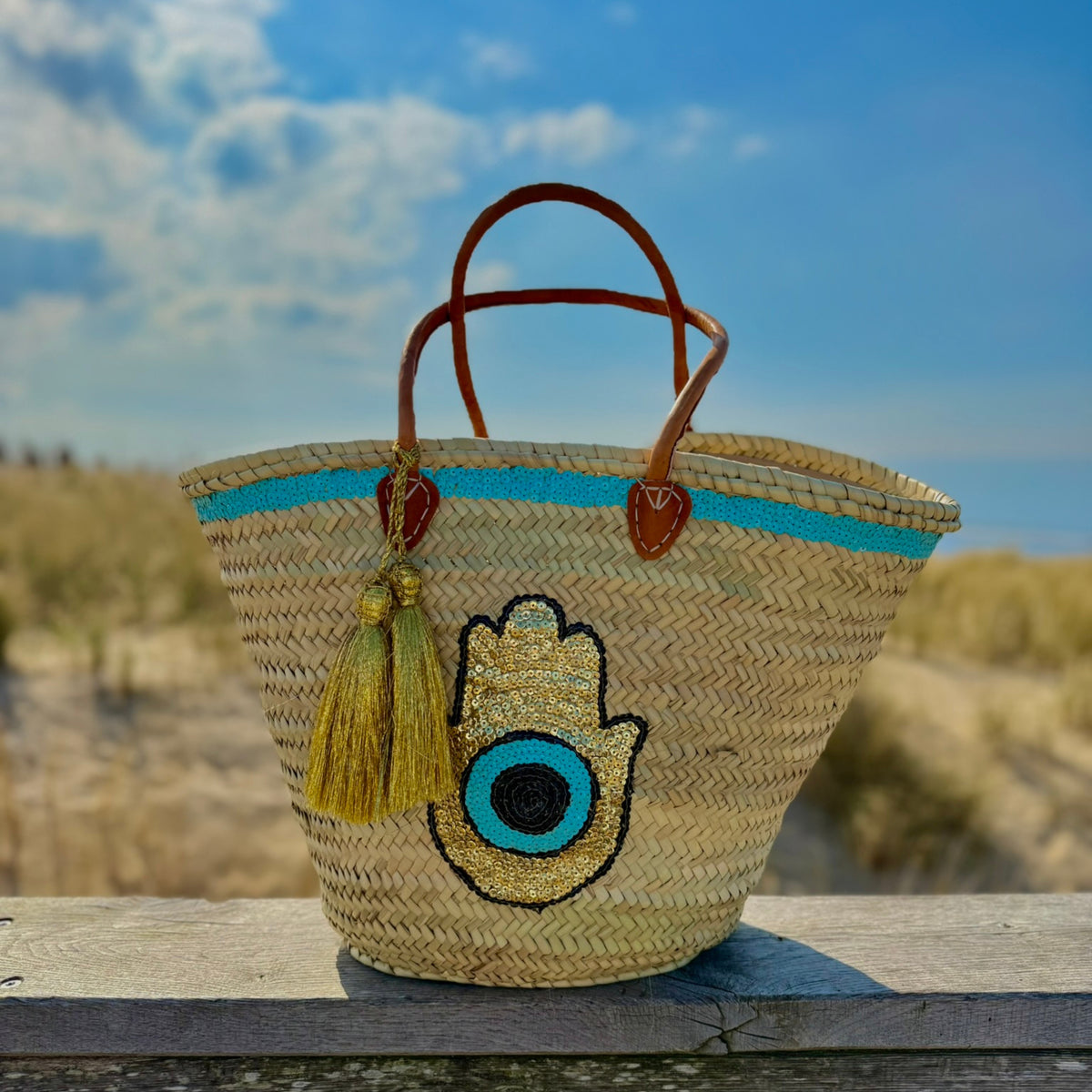 Boho rattan beach bag Hamsa Marrakech, front view in the dunes