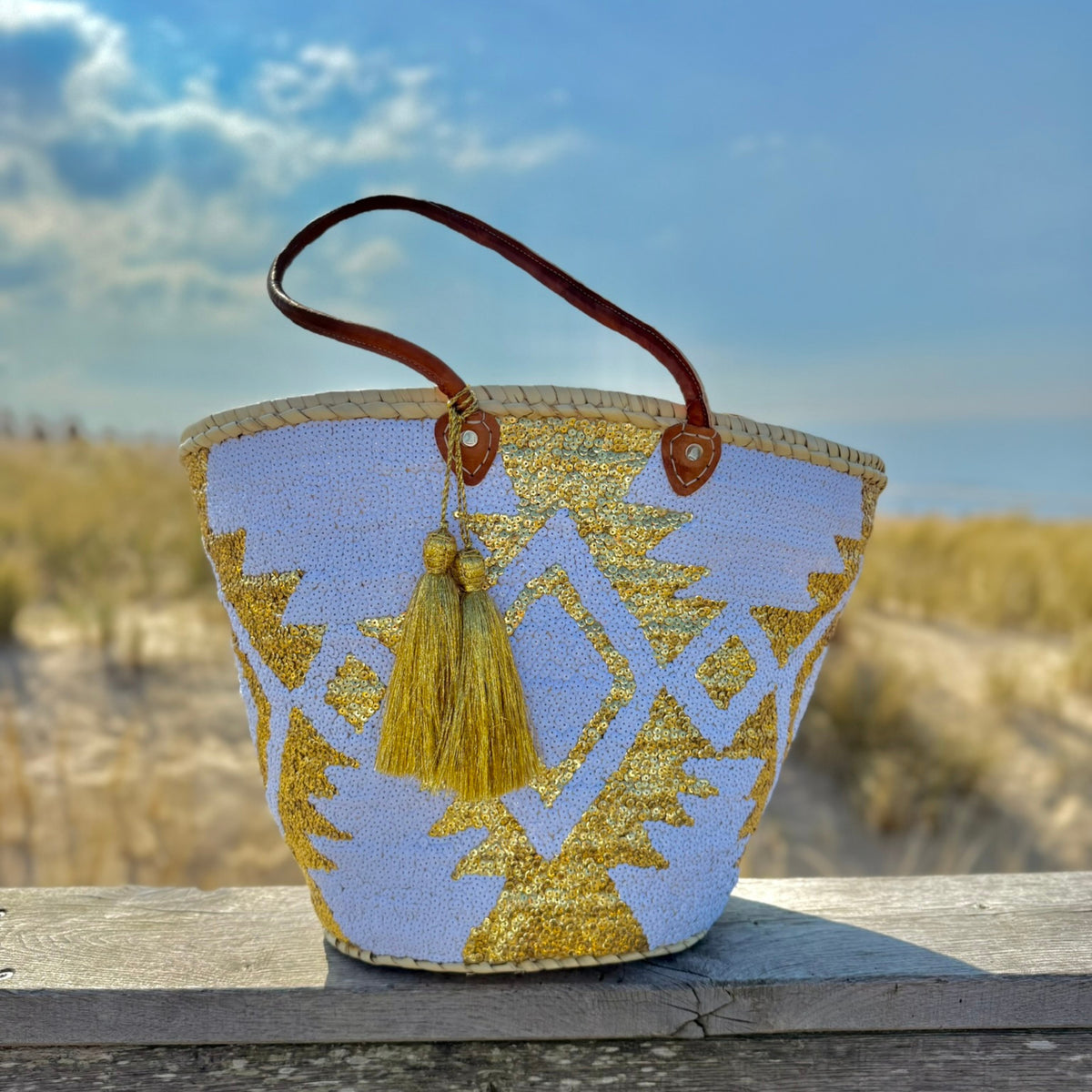 Boho rieten strandtas Aztec wit en goud, vooraanzicht in de duinen